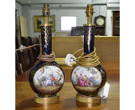 Pair of porcelain bottle vases, painted reserves of a couple in a garden, converted to lamp bases, height to fitments 41cm.