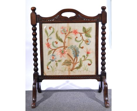 Oak framed firescreen, carved pediment, bobbin-turned supports, splayed legs, needlework floral panel, width 69cm, height 89c