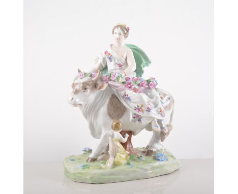 A Dresden porcelain group, Europa and the Bull, modern figure with billowing cloak and rose festoons, attended by cherub, 26c