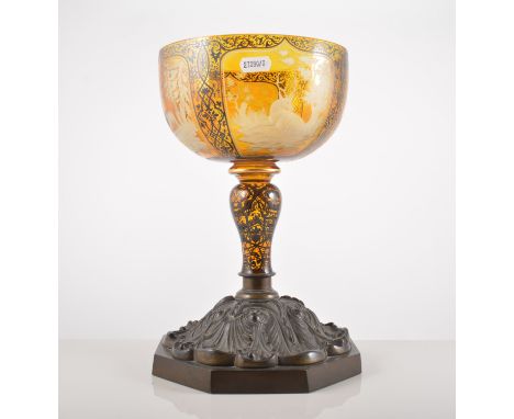 Bohemian amber overlaid goblet, wheel engraved panels, painted in black enamel, damaged, adapted on a bronzed base, 30cm.