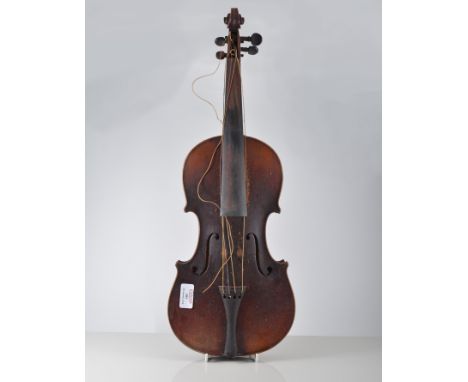 An old violin, dark stained two piece 36cm back, labelled Antonia Stradivarius with bow in a wooden case.