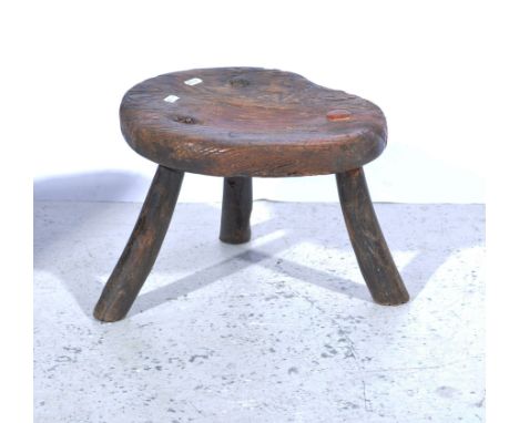 Elm milking stool, circular top on three splayed legs, top diameter approximately 31cm, height 25cm, a mahogany plant stand w