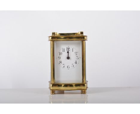 French brass cased carriage clock, serpentine outlines, white enamel dial, platform escapement, 14cm in a morocco travelling 