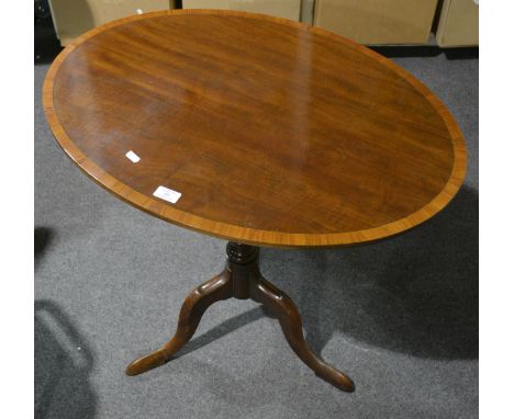 A late Victorian mahogany pedestal table, oval tilt top with satinwood crossbanding, ringed column, on tripod legs,
75 x 55cm