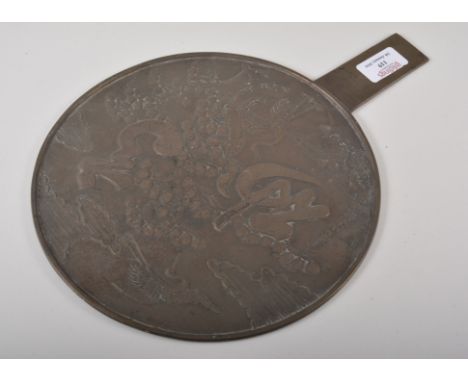 A Chinese cast bronze hand mirror, probably Republic period, circular face, cast back decoration with wading birds, trees and