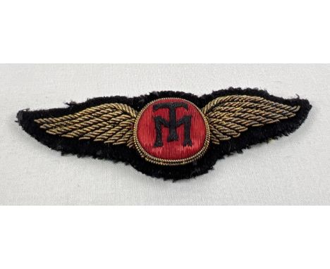 A bullion thread wings badge with embroidered TM to central panel. Approx. 9cm long. 