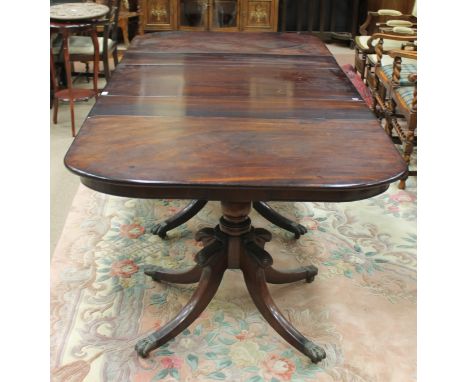REGENCY MAHOGANY TRIPLE PILLAR EXTENDING D-END DINING TABLEwith pembroke centre, on three turned baluster pillars, each with 