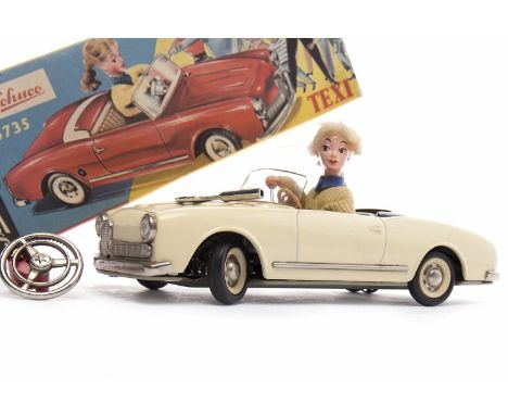 SCHUCO 5735 TEXI TINPLATE CLOCKWORK OPEN-TOP CARin cream with female driver, printed interiors and chrome fittings, clear pla