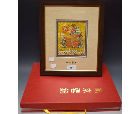 A Chinese Nanjing Yun brocade, embroidered in silk with a dragon chasing a flaming pearl, framed, silk box