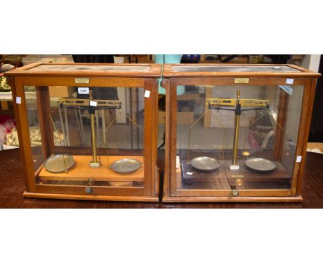 Scientific Instruments - a set of laboratory balance scales, glass cased; another set similar; cased weights