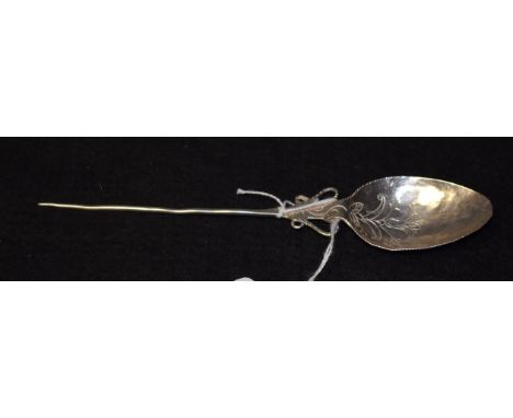 An 18th century silver coloured metal spoon, the bowl chased with a stylised flower, mote type terminal, 18.5cm long
