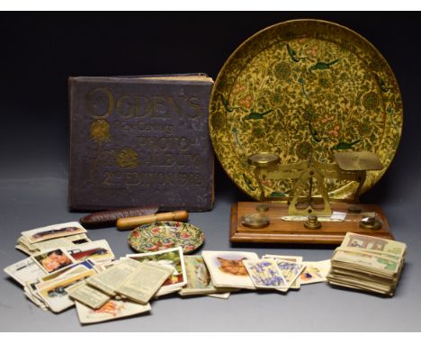 A set of postal scales with weights; a treen pipe cleaning tool with tamper in leather case; an lacquer Persian gilded plaque