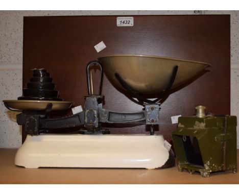 A set of early 20th century white enamel kitchen scales and weights; an early 20th century cold painted tin signalling lamp, 