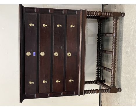An early 19th century joined oak chest of four drawers on bobbin turned stand, the sides panelled. 44'w x 52'h