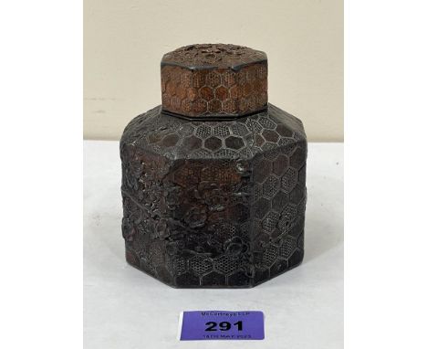 A Chinese octagonal bronzed metal tea caddy and cover, decorated in relief with prunus. 4¼' high
