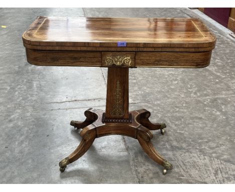 A Regency rosewood cut brass and line inlaid card table on quadripartite outswept support. 36' wide