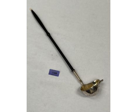 A white metal toddy ladle with gilt bowl and turned treen handle. Apparently unmarked. 17½' long