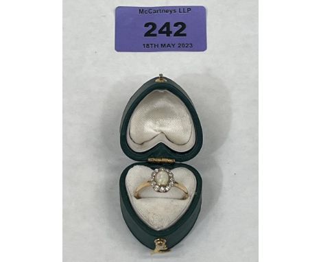 An opal and diamond cluster ring. Apparently in gold but unmarked. 2g gross. Size O