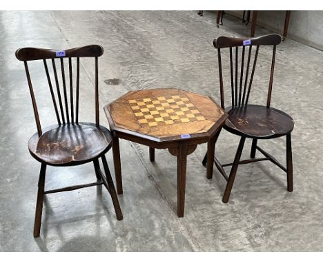 A walnut and inlaid chessboard topped table and a pair of stickback chairs