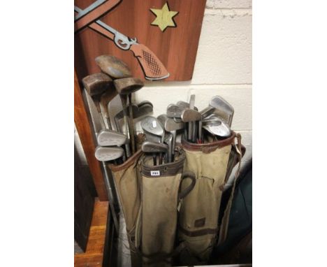 Three vintage golf bags with approx. 29 vintage golf clubs  