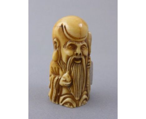 Bone netsuke of an old man with stake