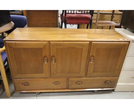 Ercol pale elm sideboard with three cupboards (one with cutlery tray) over two drawers