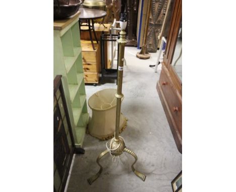 Heavy early 20th Century brass standard lamp raised on three scroll legs  