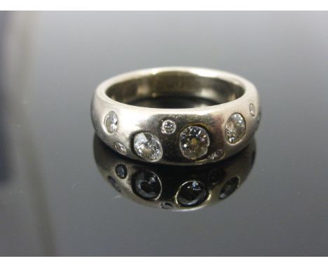 Contemporary 18ct White Gold Ring inset with Nine Diamonds of Varying Sizes