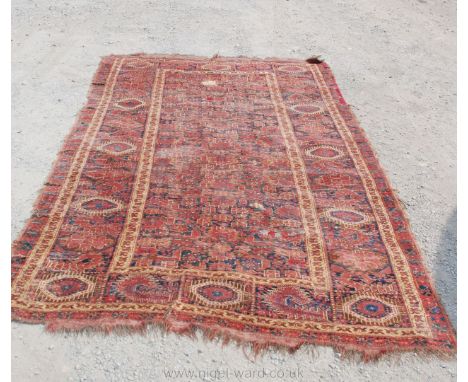 An antique Persian Rug, geometric pattern with panel and two borders, some damage and repairs, 121" long x 66" wide