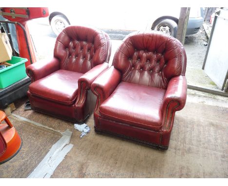 A pair of red leather button back, scroll arm Easy Chairs