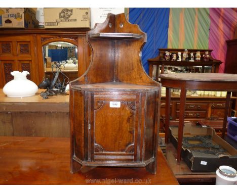 An Edwardian Beech small wall hanging Corner Cabinet with upper shelf over single panel door, 14'' wide x 26'' high x 8 1/2''