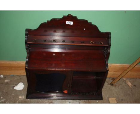 A wall mounted Edwardian Mahogany smoker's Cabinet having single stained glass door, shelf with pierced apron and lower pipe 