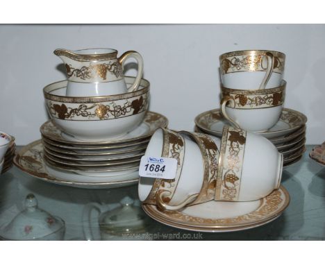 A Noritake Teaset with gold vines around rim, to include bread and butter plate, six tea plates, five cups, six saucers, milk