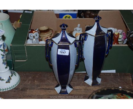 A pair of Wedgwood hexagonal slim lidded Vases with alternate light and royal blue honeycomb pattern sides