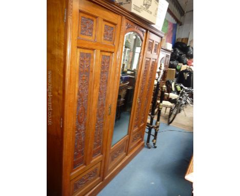 A good 19th c. Walnut three door Compactum/Wardrobe, central bevel plated mirrored door, flanked by two five carved panel doo