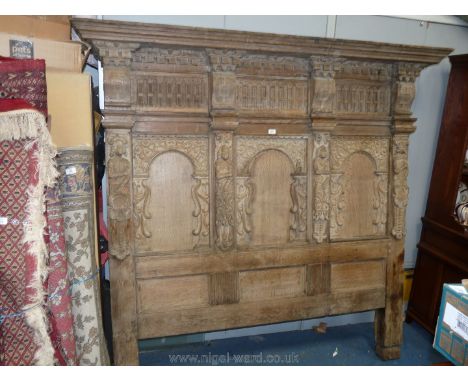 A 17th c. and later Oak  Bed Panel, with probably 19th c. moulded cornice, over three upper carved panels between corbels ove