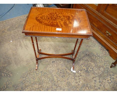 A reproduction Occasional Table, Walnut finished with inlaid oval panel to the rectangular top, standing on slender turned le