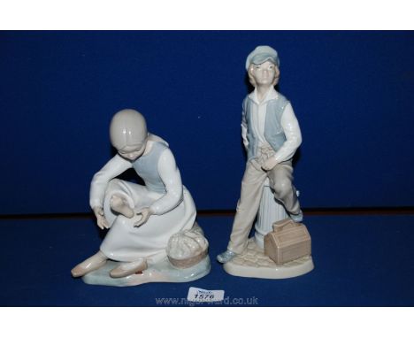 Two Nao figurines: 'Shoeshine Boy' and a young lady looking at her sore foot