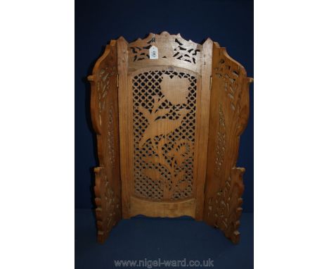An ornate wooden Firescreen