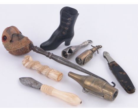 Collection of various items,
including a carved ivory pipe tamp in the form of a serpent and fist, 3 champagne bottle and sod