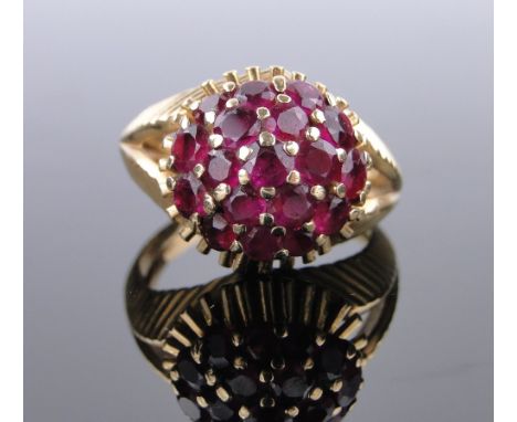 A Tiffany unmarked gold ruby cluster Bombe shaped cocktail ring,
with feather design shoulders, setting 13mm across, size Q.