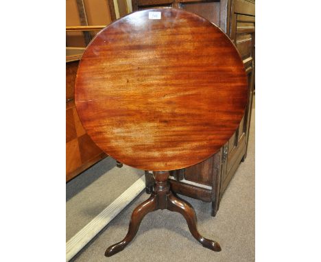 An Antique mahogany tilt top tripod table,
width 2'1", height 2'3".