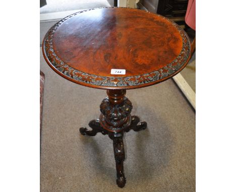 A Victorian walnut tripod table,
having carved edge, raised on a carved centre column and tripod legs, width 1'7", height 2'5