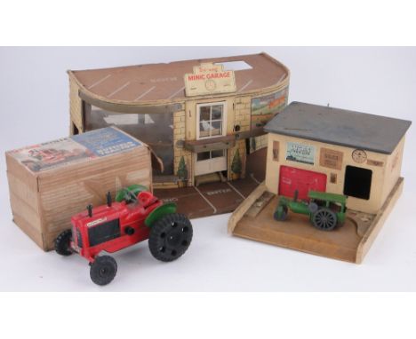 A boxed Minic clockwork powered tractor,
a Minic green steam roller length 5.25", a model service station and a Minic car sho