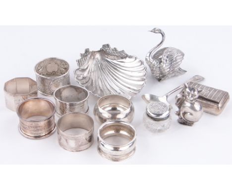 A group of silver items,
including a cat design pepperette, a 19th century snuff box, napkin rings, etc.