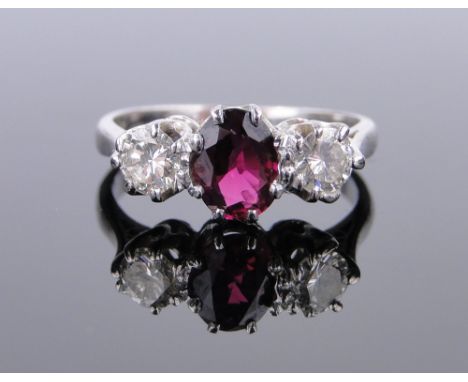 18ct white gold 3 stone ruby and diamond ring,
setting width 15mm, size K.