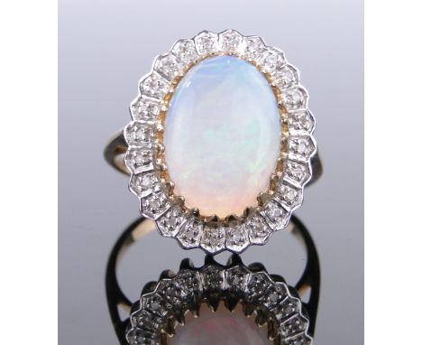 A 9ct gold opal and diamond cluster ring,
setting height 20mm, size P.