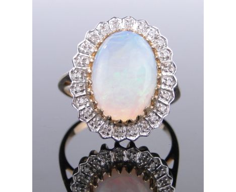 A 9ct gold opal and diamond cluster ring,
setting height 20mm, size P.