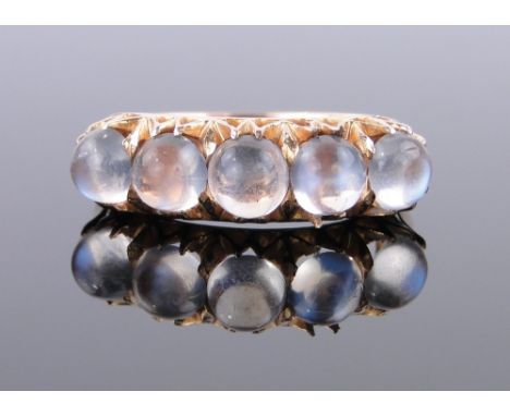 An unmarked gold 5 stone cabochon moonstone ring,
setting width 22mm, size K.