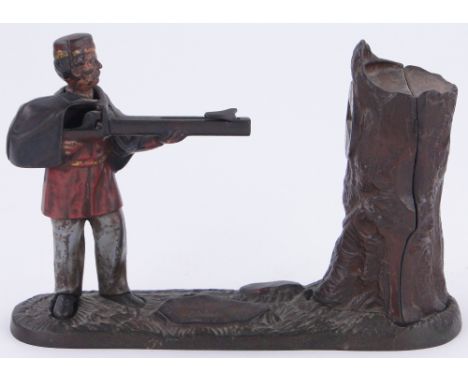 A 19th century American painted cast-iron mechanical moneybank,
rifleman aiming at a tree trunk "Creedmoor Bank" dated 1877, 